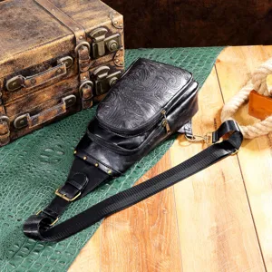 Close-up of embossed floral detailing on vintage bohemian black leather sling bag