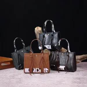Variety of vintage cow print mini handbags in different colors on rustic wood background