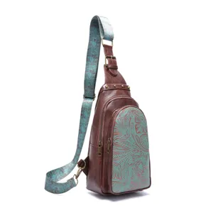 Vintage Bohemian sling bag with embossed floral pattern and adjustable strap detail