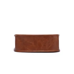 Detailed bottom view of brown vintage textured faux leather crossbody bag