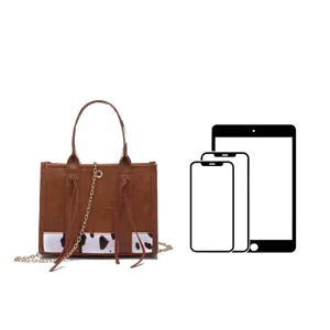 Vintage brown mini tote bag with cow print detail shown with device size comparison icons