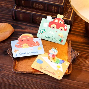 Cartoon greeting cards with octopus, car, and caterpillar illustrations on a wooden tray