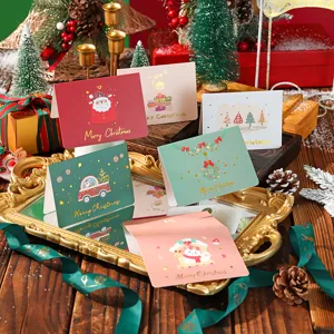 Close-up detail of creative Christmas cards with gold foil stamping and festive designs