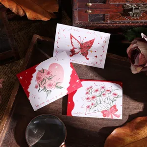 Detail view of retro rose and butterfly greeting cards on a vintage wooden tray.