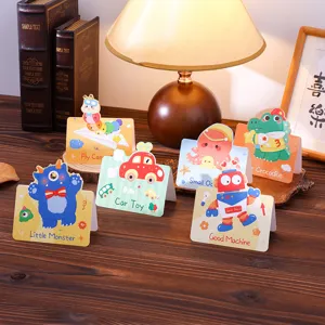 Close-up of six different cartoon animal greeting cards displayed on a wooden desk