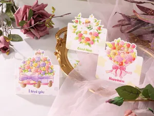 Detailed view of three cartoon greeting cards with colorful floral illustrations.