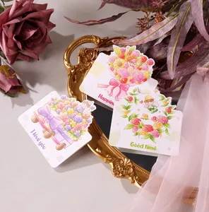 Close-up of floral cartoon greeting cards with I love you and Good time prints.