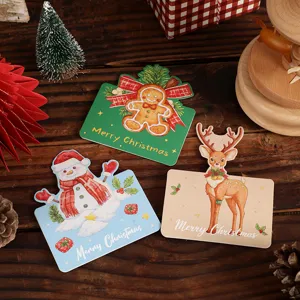 Set of three vintage Christmas hang tags with gingerbread man, snowman and reindeer designs.