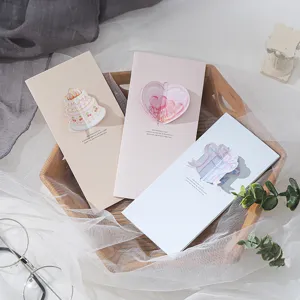 Three-piece set of 3D pop-up greeting cards with heart and cake designs in a gift setting