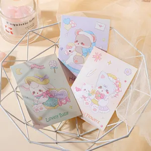 Close-up detail of cute cartoon animal greeting cards featuring lamb bear and cat designs