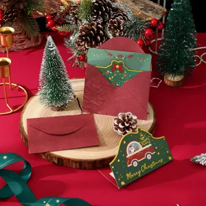 Detailed shot of Christmas gold foil shaped card and red envelope on a wood slice