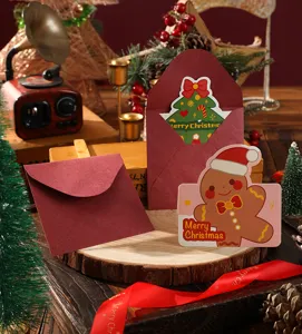 Detailed view of gingerbread man and tree Christmas cards with burgundy envelopes