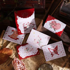 Macro view of vintage folding greeting cards featuring romantic flower bouquet illustrations
