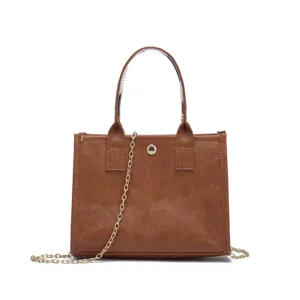 Front view of a brown vintage-style mini tote bag featuring a decorative gold chain strap