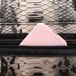 Macro view of the interior zipper pocket on a vintage snakeskin patterned tote bag for women