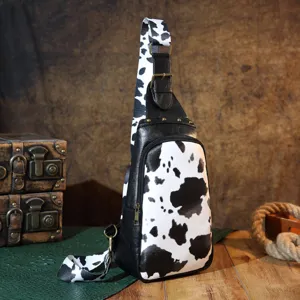 Vintage cow print sling bag with adjustable strap and retro hardware