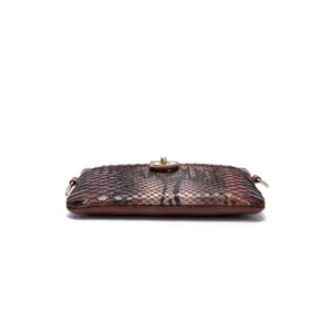 Detailed macro view of retro western style snakeskin pattern clutch bag with gold lock