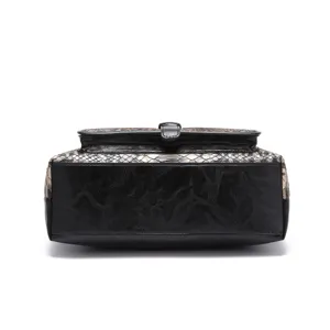 Close-up detail showing the retro snakeskin texture and black faux leather of this tote bag.