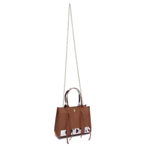 Vintage style small brown western handbag with cow print accents and gold chain strap