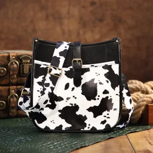 Bohemian cow print shoulder bag with black leather trim and retro buckle detail