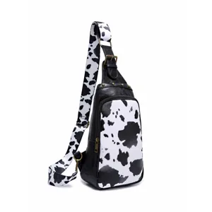 Side view showing cow print pattern and leather details of this vintage chest bag