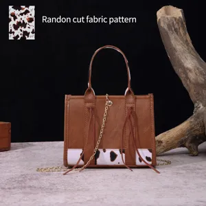 Detail of western style mini handbag featuring random cut cow print fabric pattern