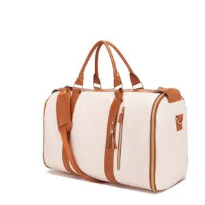 Gran bolsa de viaje de lona crema con ribetes de cuero marrón y cremalleras doradas