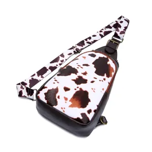 Close-up view of Western retro cow print sling bag with adjustable strap