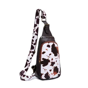 Western style cow print crossbody chest bag with brown faux leather trim detail
