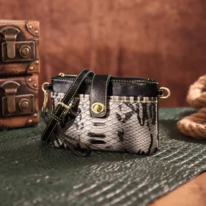 Close-up of bohemian western crossbody bag with snakeskin print and gold hardware