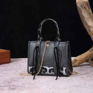 Detailed view of a vintage Boho mini handbag featuring leopard print and a gold chain strap.