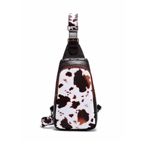 Detailed front view of Western style cow print sling bag with vintage bronze studs