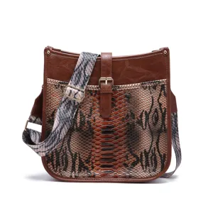 Vintage western bohemian messenger bag featuring snakeskin print and wide patterned strap