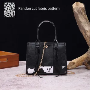 Detail of mini western tote bag showing random cut cow print fabric pattern.