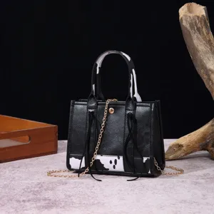 Chic vintage western bohemian mini handbag with cow print and elegant gold chain