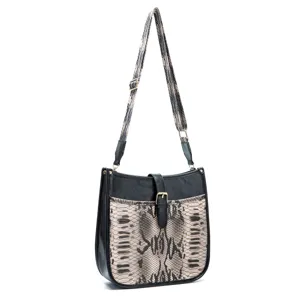 Detail of retro bohemian crossbody bag featuring faux snakeskin print and wide fabric strap