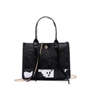 Retro western style women's crossbody bag with cow print and elegant gold chain strap