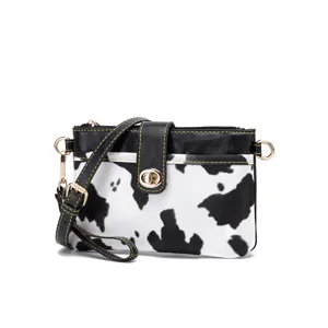 Stylish cow print crossbody bag for women with black faux leather and gold hardware