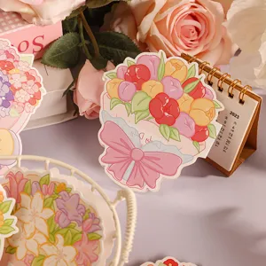 Detaillierte Nahaufnahme einer Blumengrußkarte mit rosa Schleife und „Lovely Day“-Text.