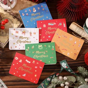 Assortment of festive gold-stamped Christmas greeting cards arranged on a wooden table