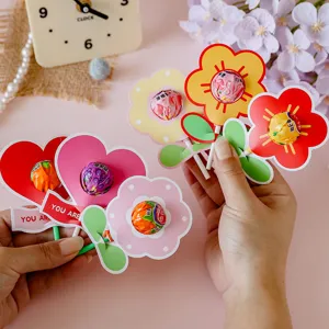 Hands holding decorative flower and heart shaped lollipop cards for student gifts