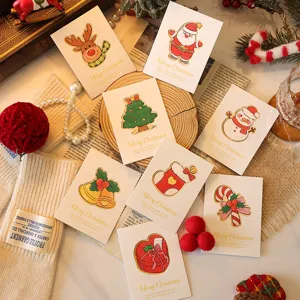 Festive Christmas greeting cards with assorted holiday illustrations and gold script.