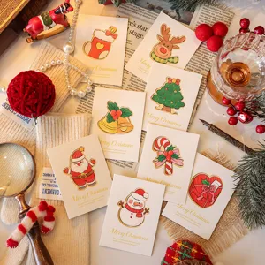 Detailed view showing a variety of Christmas cards with festive designs and gold foil accents.