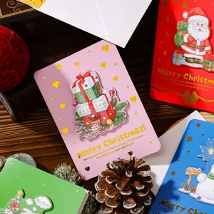 Detailed view of 3D Christmas greeting cards with gold foil lettering and envelopes