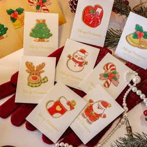Assorted mini hollow Christmas greeting cards with festive cartoon characters and gold foil