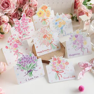 Verschiedene Blumenstrauß-Grußkarten mit Segenssprüchen auf Holzständer