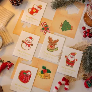 Close-up detail of festive hollow-out Christmas cards with cute illustrated tags.