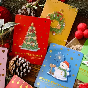 Close-up of 3D Christmas cards with gold stamping and festive designs.