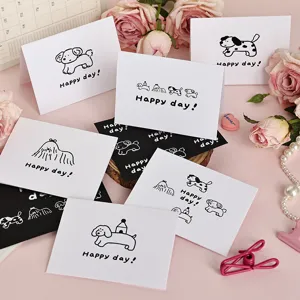 Juego de tarjetas de felicitación en blanco y negro con dibujos de perros y texto