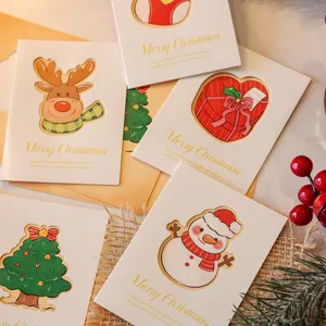 Detail view of rustic die-cut Christmas cards featuring reindeer and snowman on burlap